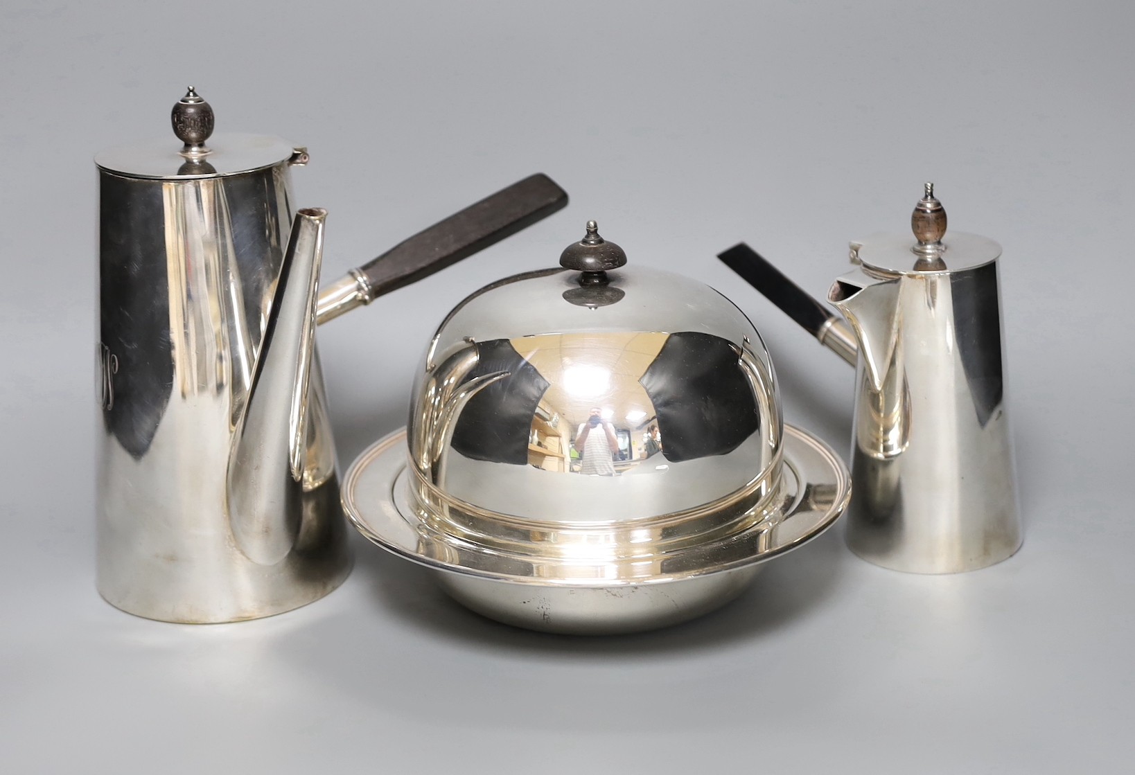 Two silver plated cafe au lait pots one with double wall interior and a muffin dish